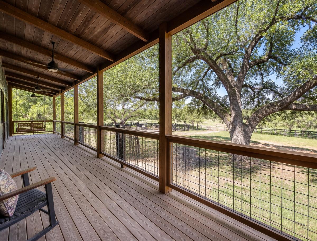 Covered porch and deck with cattle panel railing in Victoria County